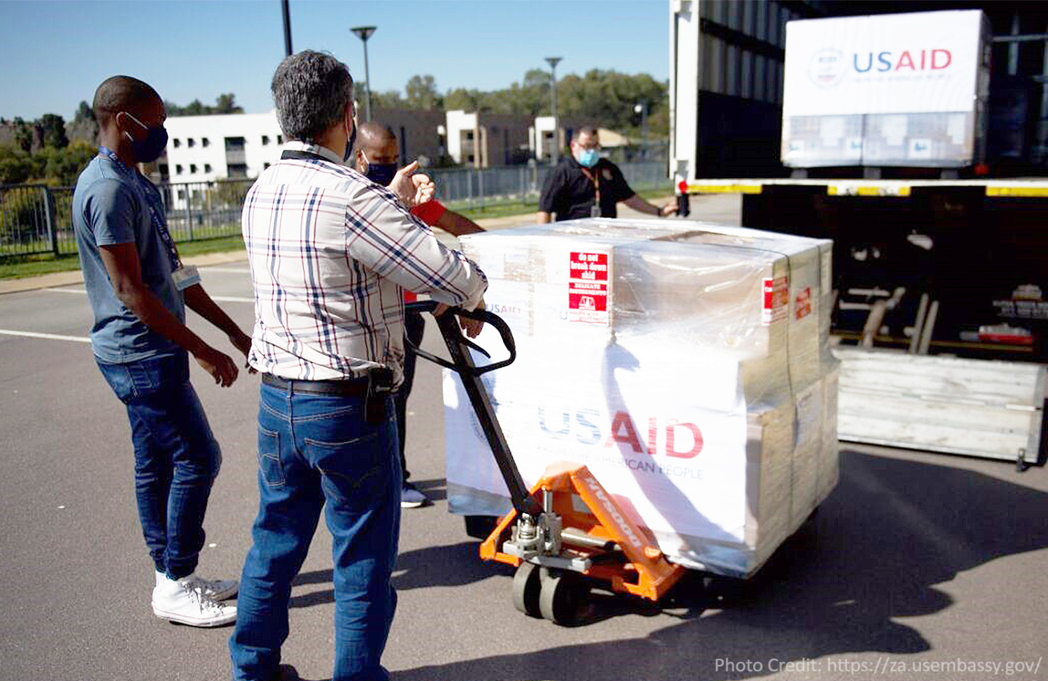 Men loading boxes of ventilators