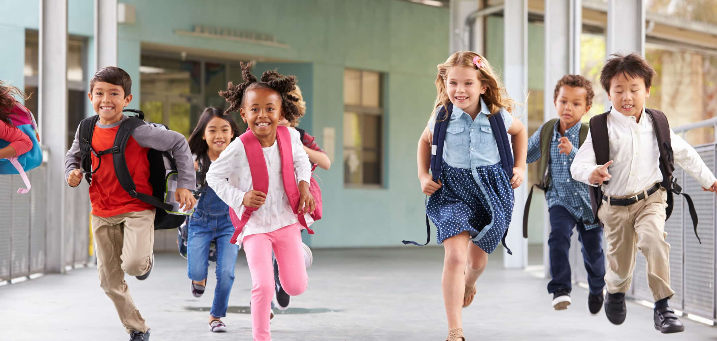 kids running in front of a school