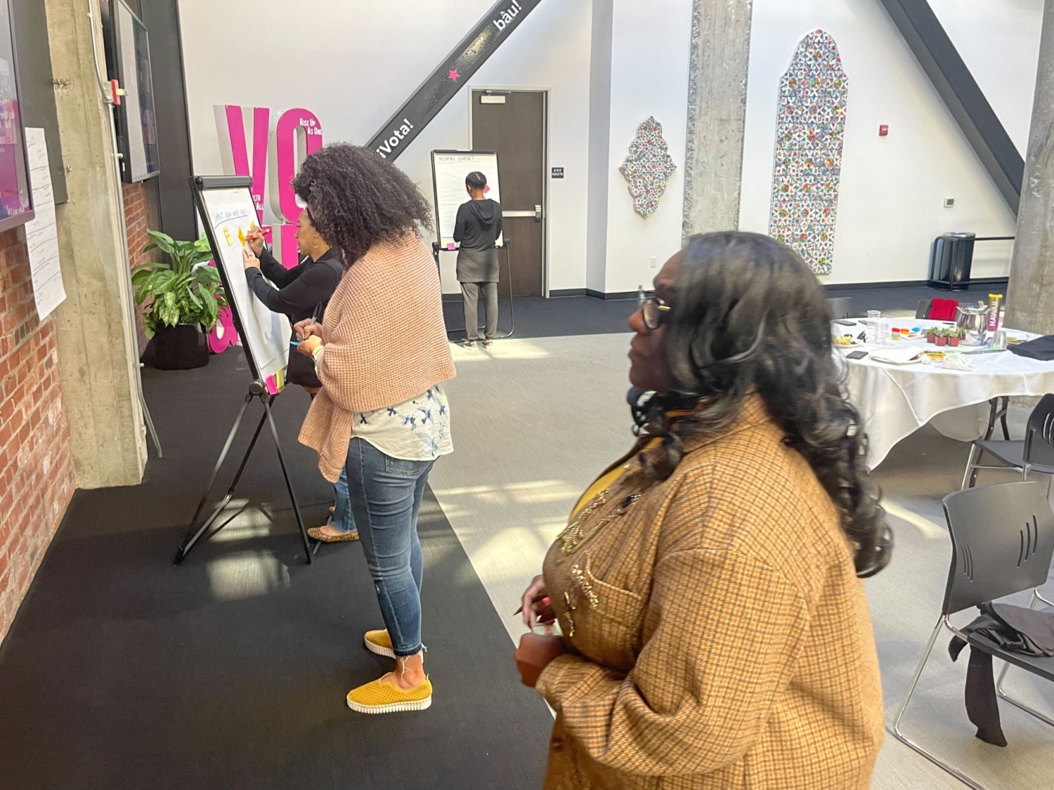 women writing on poster board