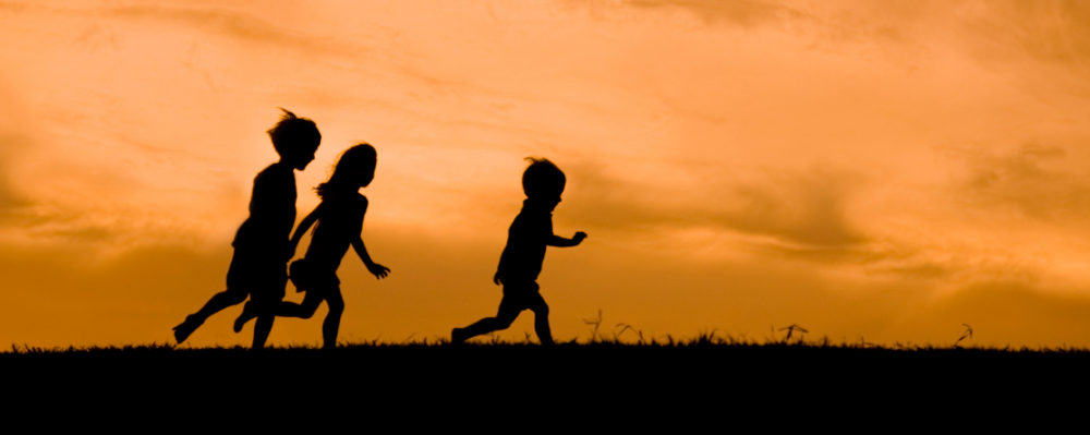 silhouette of children running