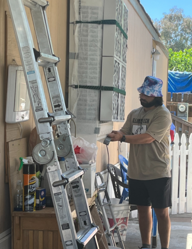 FRESSCA researcher adding a filter to an outdoor swamp cooler