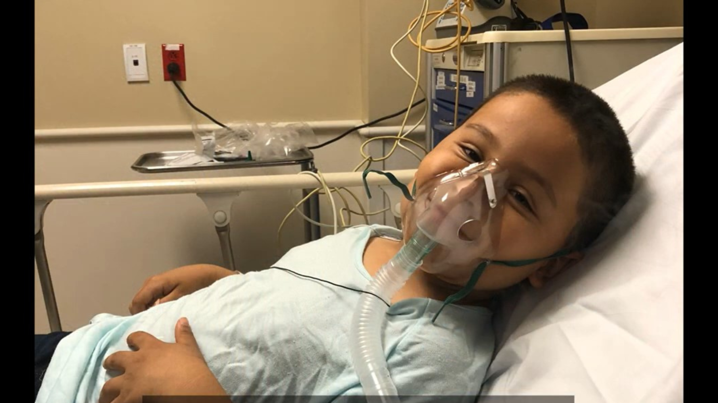 boy in hospital and wearing an air respirator for asthma