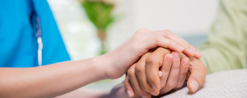 doctor holding patients hand