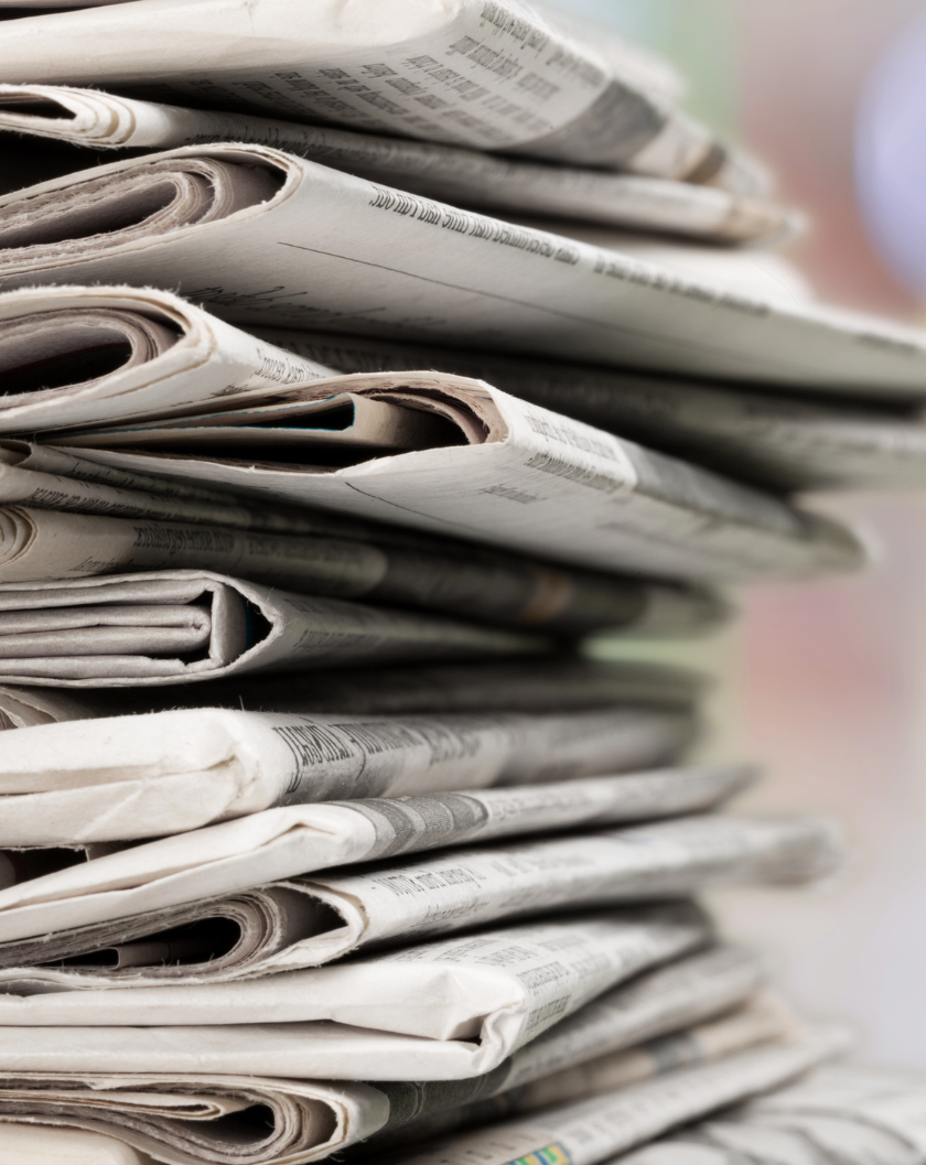 Pile of Printed Newspapers on Background