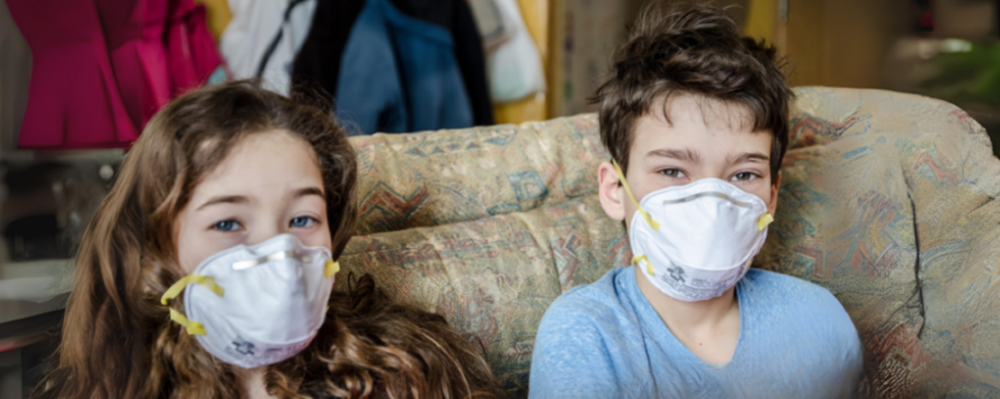 two children wearing N95 masks