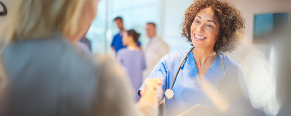 doctor shaking hands with woman