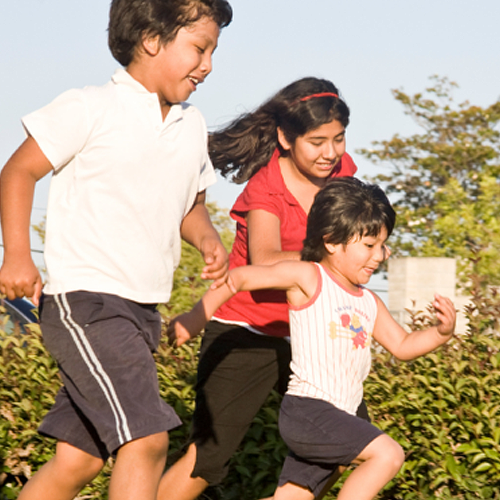 three kids running in park