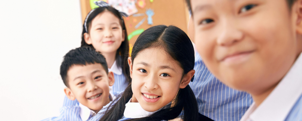 Asian youth sitting next to each other and smiling