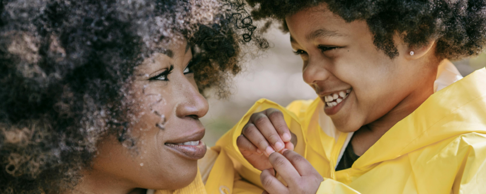 woman looking at child and smiling