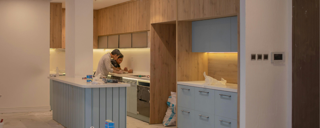 two countertop workers talking to each other