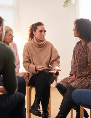 woman speaking in circle of people