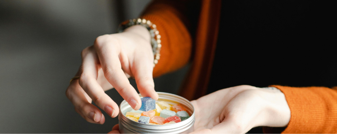 person holding a jar of CBD candies