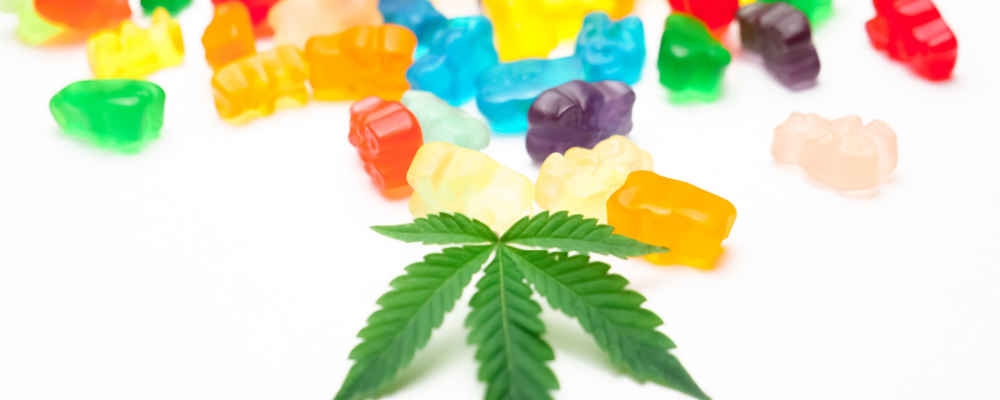 marijuana leaf next to cannabis gummies