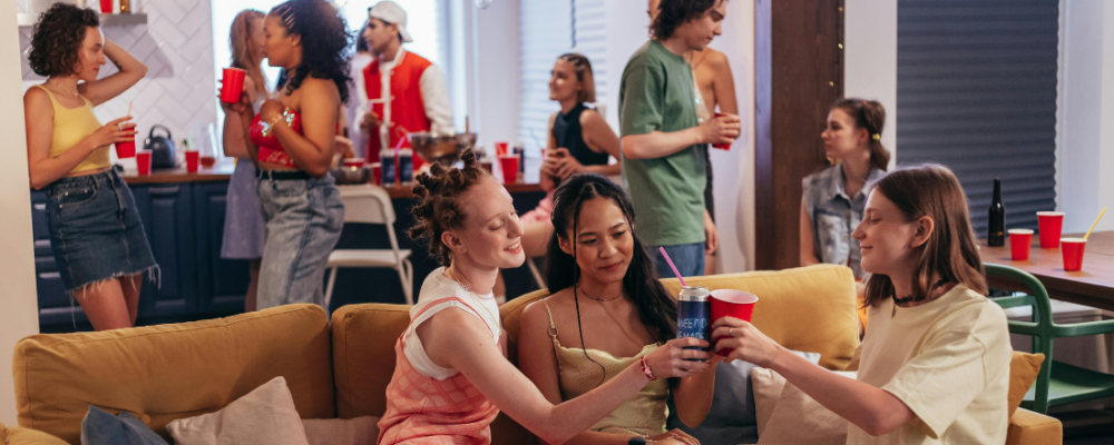 young adults drinking alcohol at a house party