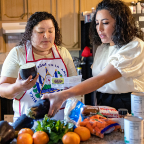 Healthy Food Rx participants in Stockton, CA unpack a food box with cooking instructions