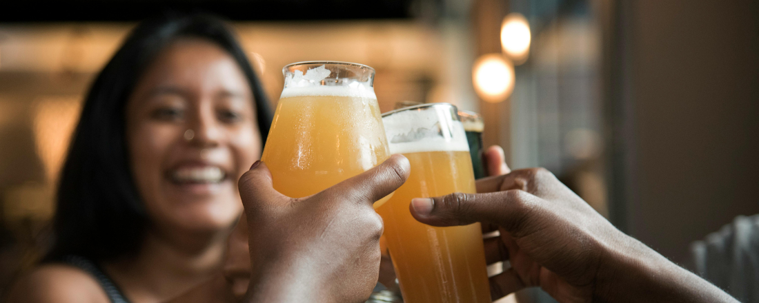 group of people toasting with a glass of alcohol