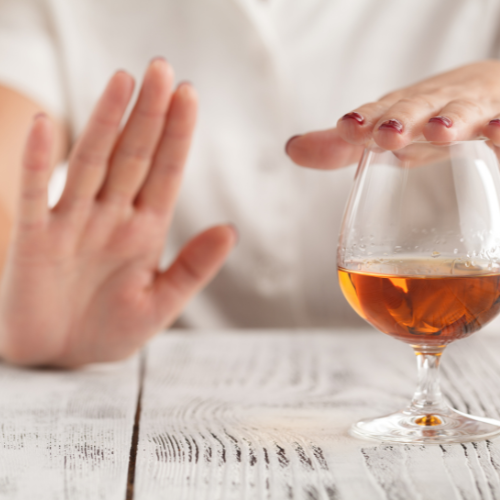 person putting hand in front of alcohol